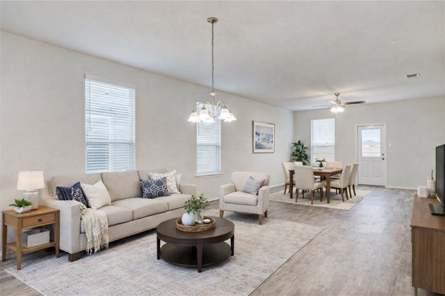 412 Ibis Falls Loop Jarrell, TX 76537 - Photo 7 of 28 a living room with furniture and a chandelier