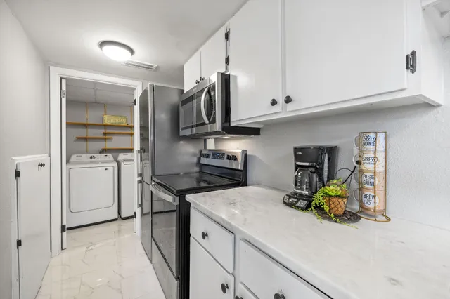 a kitchen with a sink stainless steel appliances and cabinets