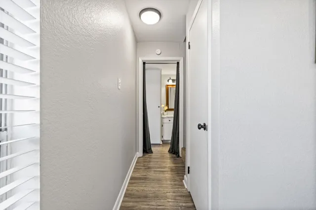 a view of a hallway with wooden floor