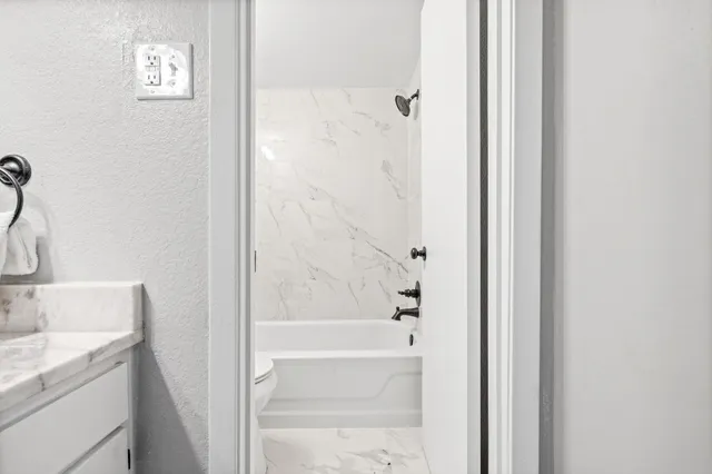 a bathroom with a granite countertop sink