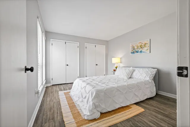 a bedroom with a bed and wooden floor