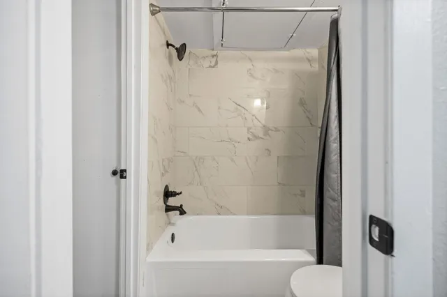 a bathroom with a bathtub and a shower