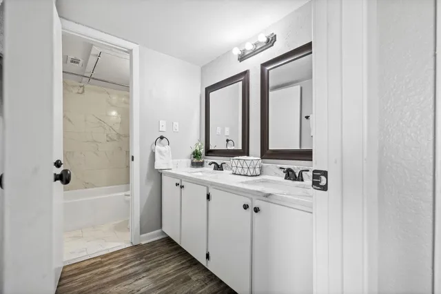 a bathroom with a double vanity sink mirror and double