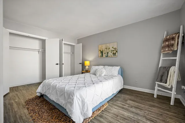 a bedroom with a bed and a rug