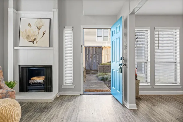 a view of a livingroom with a fireplace and window