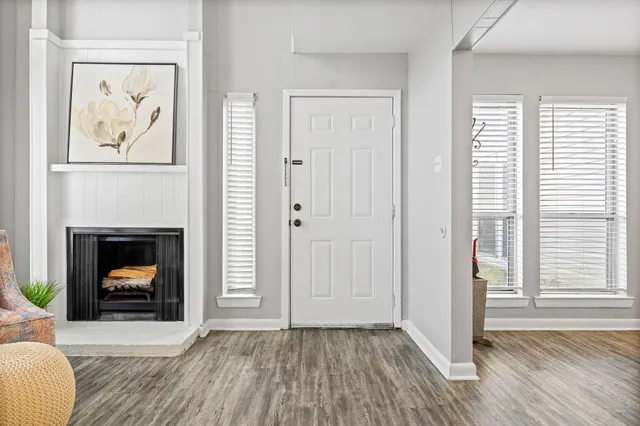 a view of a livingroom with a fireplace and window
