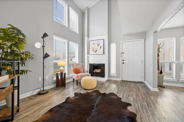 a living room with furniture a window and a fireplace
