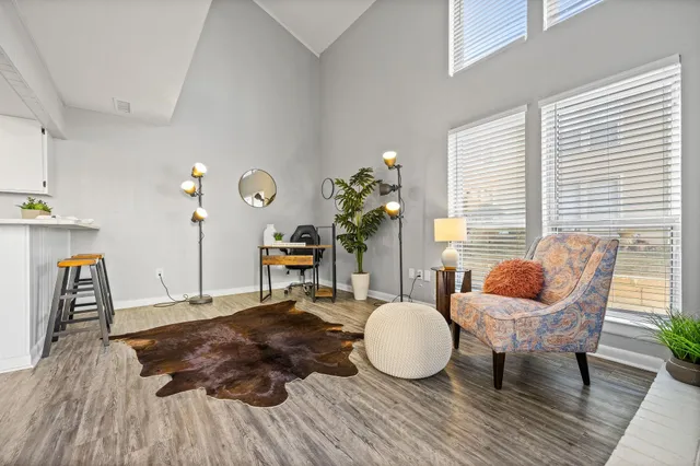 a living room with furniture and wooden floor