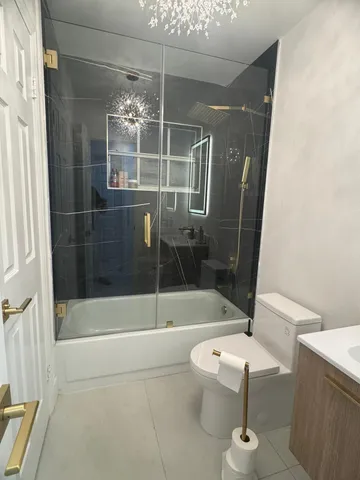 a bathroom with a shower and a toilet