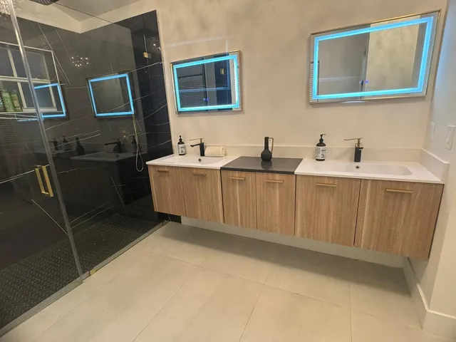 a spacious bathroom with a mirror and a sink