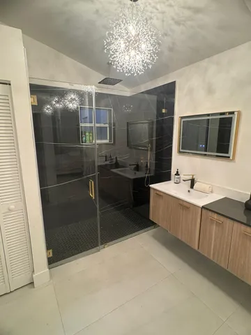 a bathroom with a tub sink a mirror and a shower