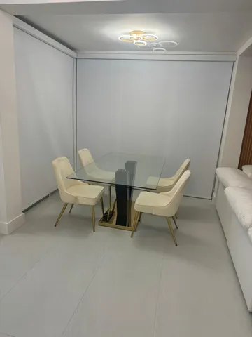 a view of a room with furniture and a chandelier