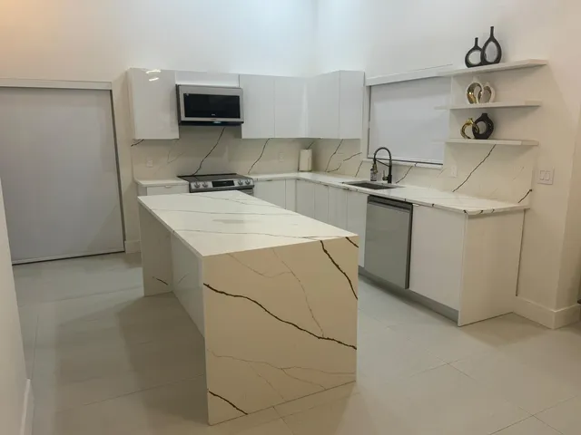 a kitchen with a sink cabinets and appliances
