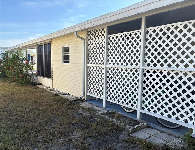 a view of a house with backyard and porch
