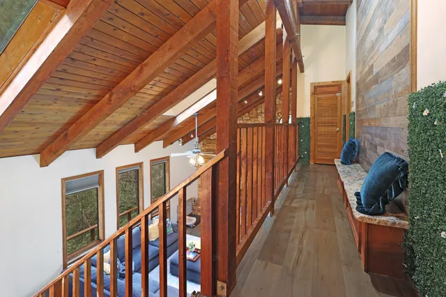 a living room with furniture a couch and a bookshelf