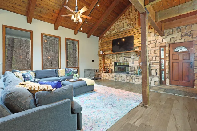 a view of a dining room with furniture a chandelier and wooden floor
