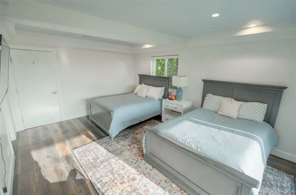 a bedroom with a bed and glass door