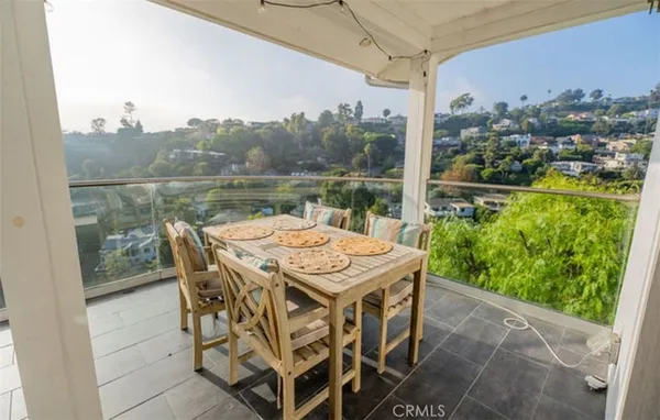 a terrace with outdoor seating and city view