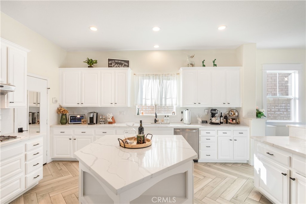 8824 Soothing Court Corona, CA 92883 - Photo 16 of 50 a kitchen with sink stove and cabinets