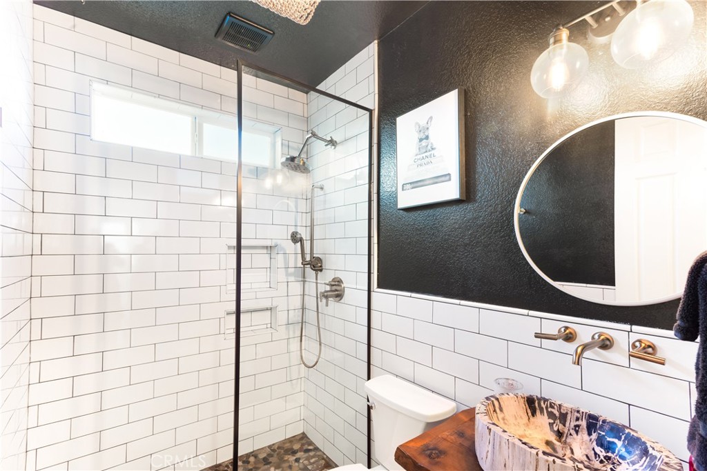 8824 Soothing Court Corona, CA 92883 - Photo 21 of 50 a bathroom with a sink mirror and shower