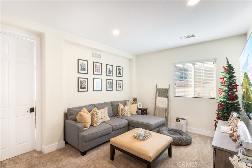 8824 Soothing Court Corona, CA 92883 - Photo 22 of 50 a living room with furniture and a potted plant