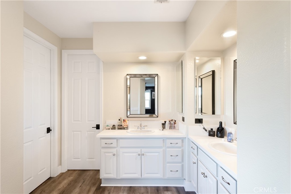 8824 Soothing Court Corona, CA 92883 - Photo 25 of 50 a spacious bathroom with double vanity a mirror and a bathtub