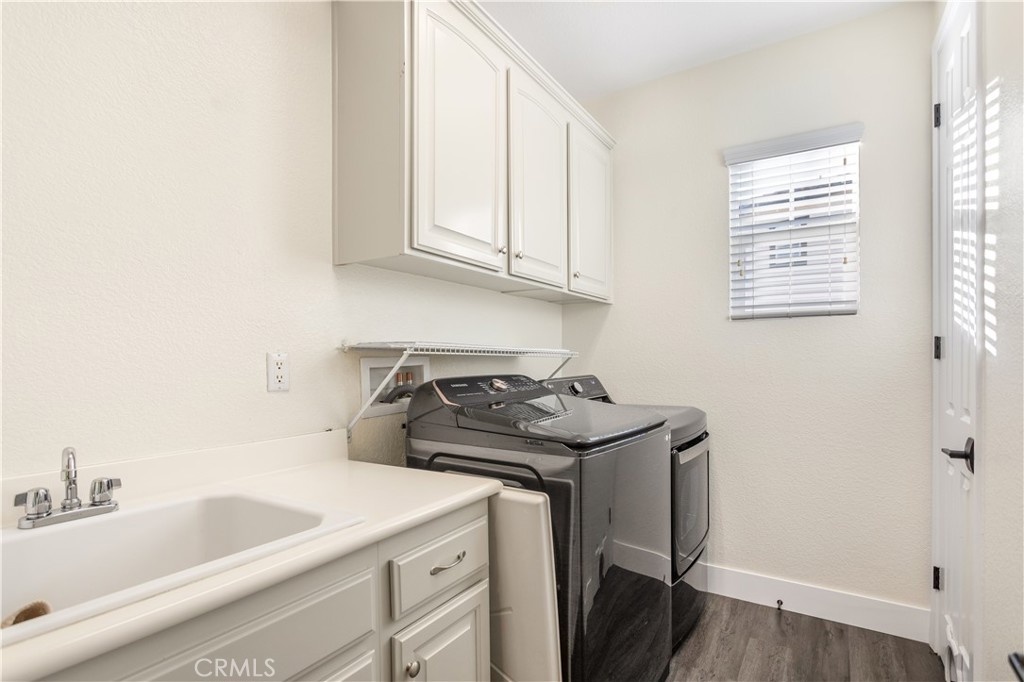 8824 Soothing Court Corona, CA 92883 - Photo 28 of 50 a kitchen with a sink a stove and cabinets