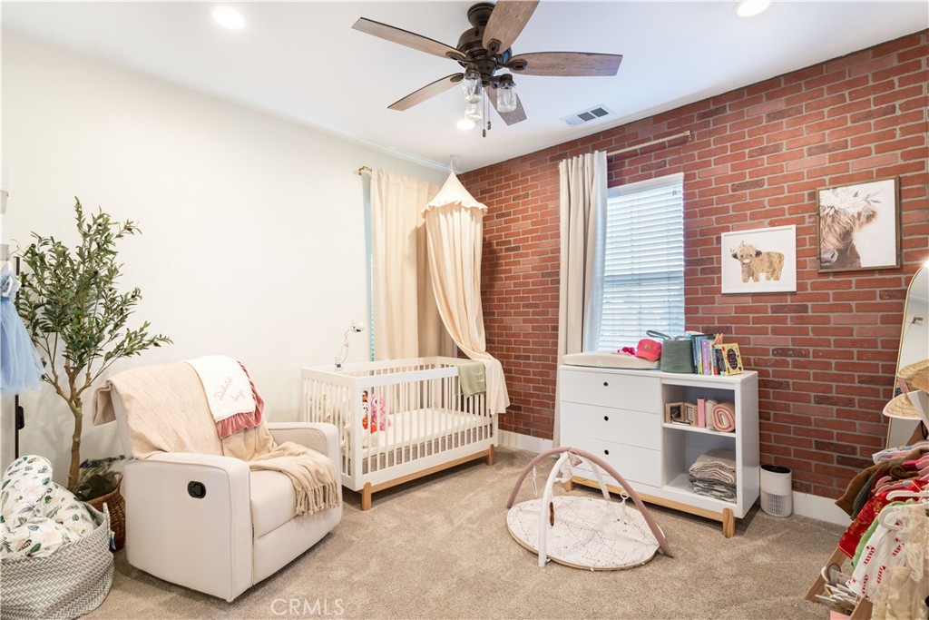 8824 Soothing Court Corona, CA 92883 - Photo 31 of 50 a living room with furniture and a flat screen tv