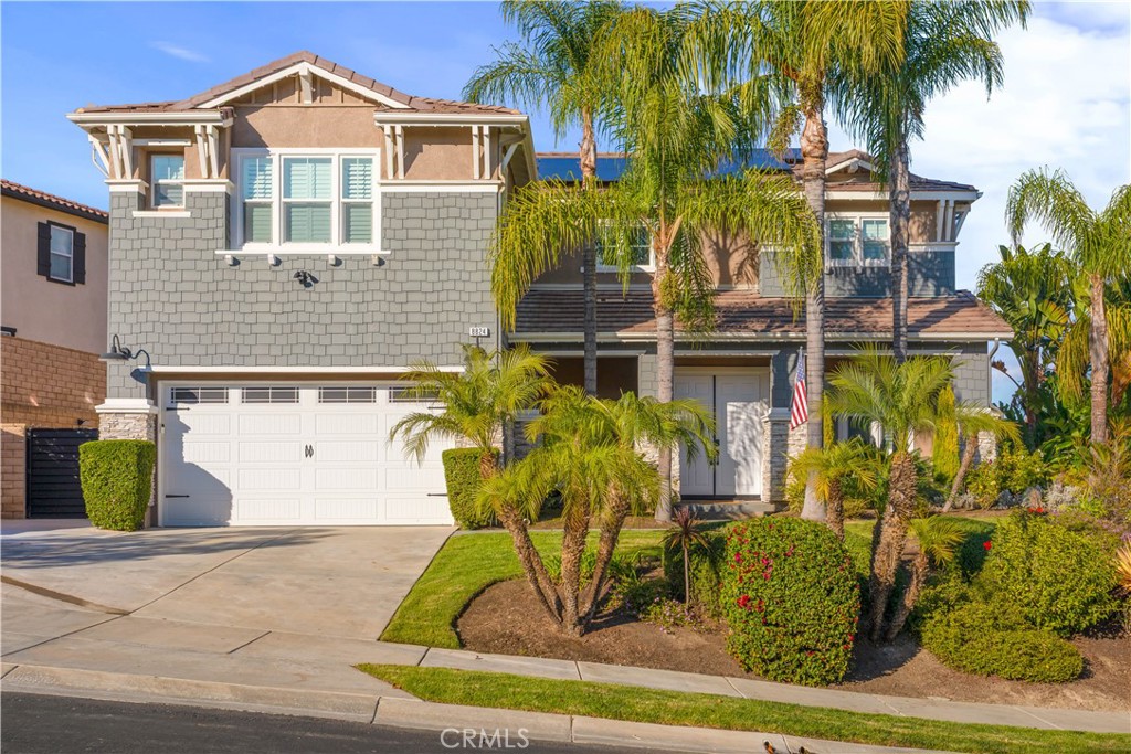 8824 Soothing Court Corona, CA 92883 - Photo 4 of 50 a front view of a house with garden