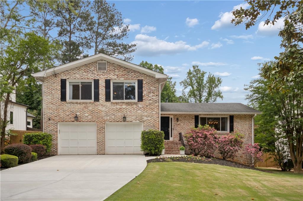 1493 Runnymeade Road Northeast Brookhaven, GA 30319 - Photo 1 of 40 front view of a house with a yard