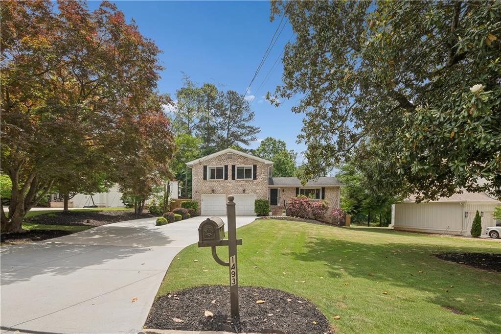 1493 Runnymeade Road Northeast Brookhaven, GA 30319 - Photo 2 of 40 a house view with a garden space