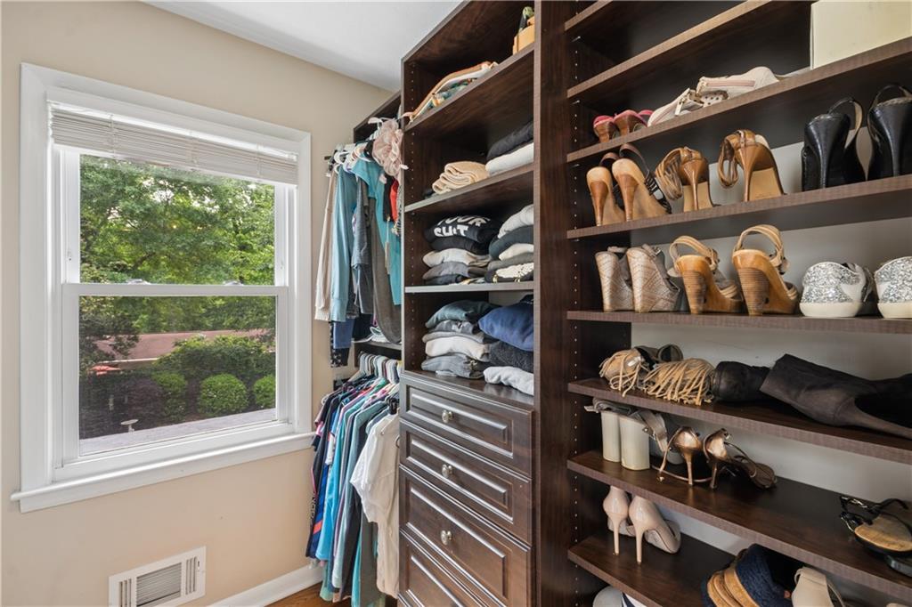 1493 Runnymeade Road Northeast Brookhaven, GA 30319 - Photo 25 of 40 a view of walk in closet with clothes and shoes