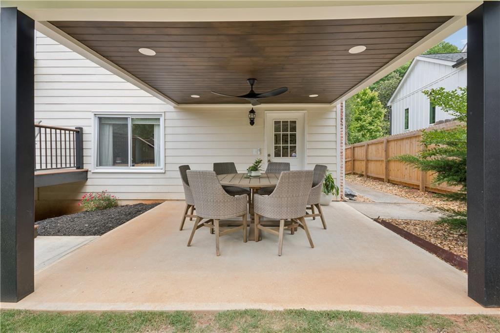1493 Runnymeade Road Northeast Brookhaven, GA 30319 - Photo 35 of 40 a view of a patio with table and chairs with wooden floor and fence