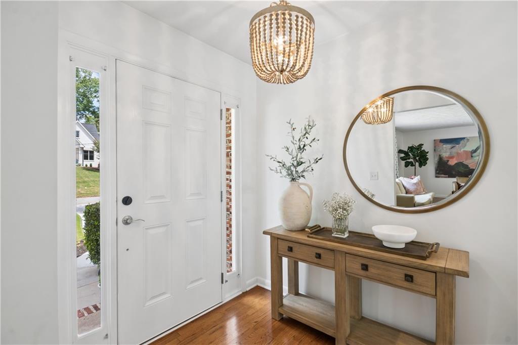 1493 Runnymeade Road Northeast Brookhaven, GA 30319 - Photo 6 of 40 an entryway with wooden floor and mirror