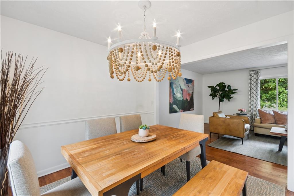 1493 Runnymeade Road Northeast Brookhaven, GA 30319 - Photo 10 of 40 a view of a dining room with furniture and chandelier