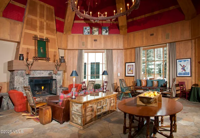 a living room with fireplace furniture and a large window