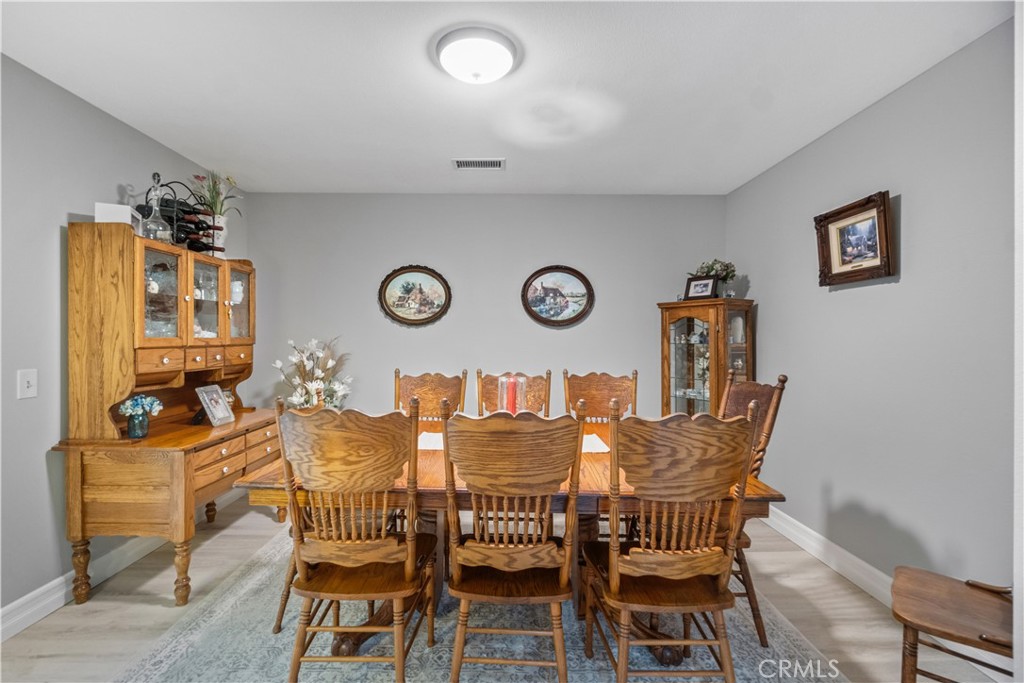 2671 Condor Circle Corona, CA 92882 - Photo 11 of 44 a view of a dining room with furniture and wooden floor