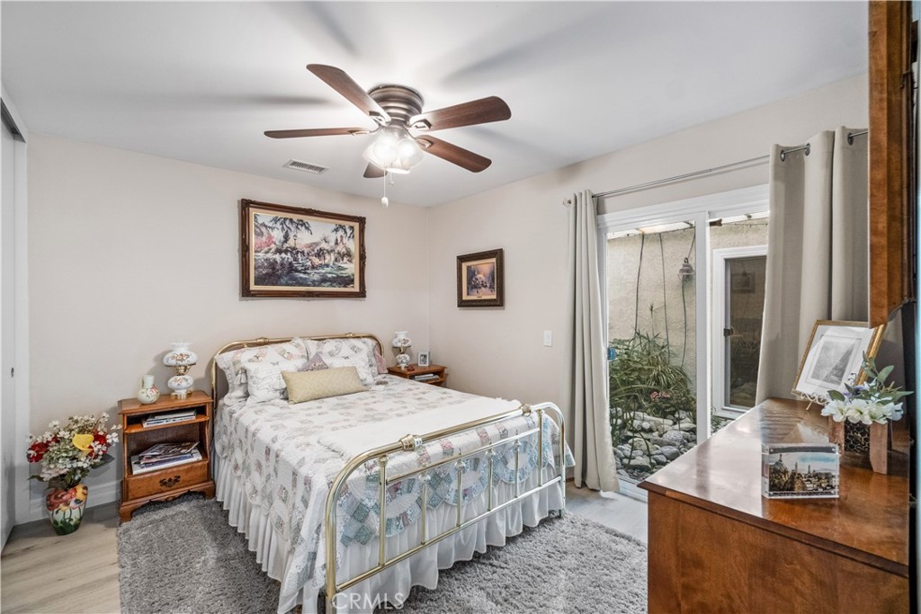 2671 Condor Circle Corona, CA 92882 - Photo 17 of 44 a bedroom with a bed and a chandelier