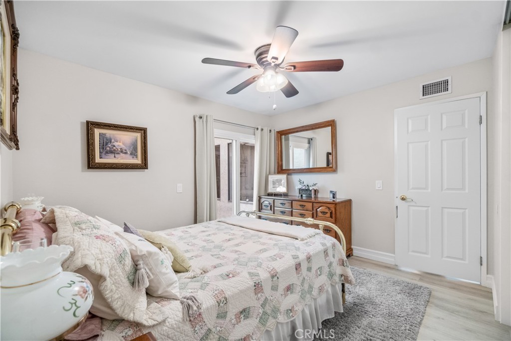 2671 Condor Circle Corona, CA 92882 - Photo 18 of 44 a bedroom with a bed and a chandelier