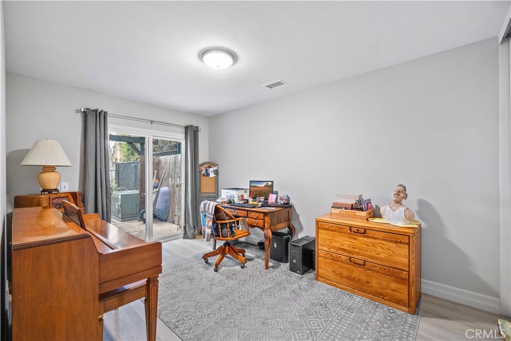 2671 Condor Circle Corona, CA 92882 - Photo 28 of 44 a room with a baby bed a couch and a window