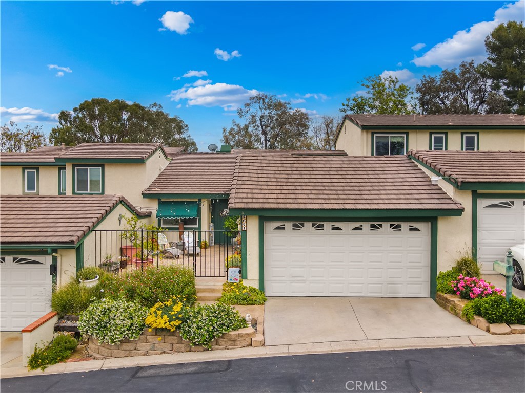 2671 Condor Circle Corona, CA 92882 - Photo 3 of 44 a front view of a house with a garden