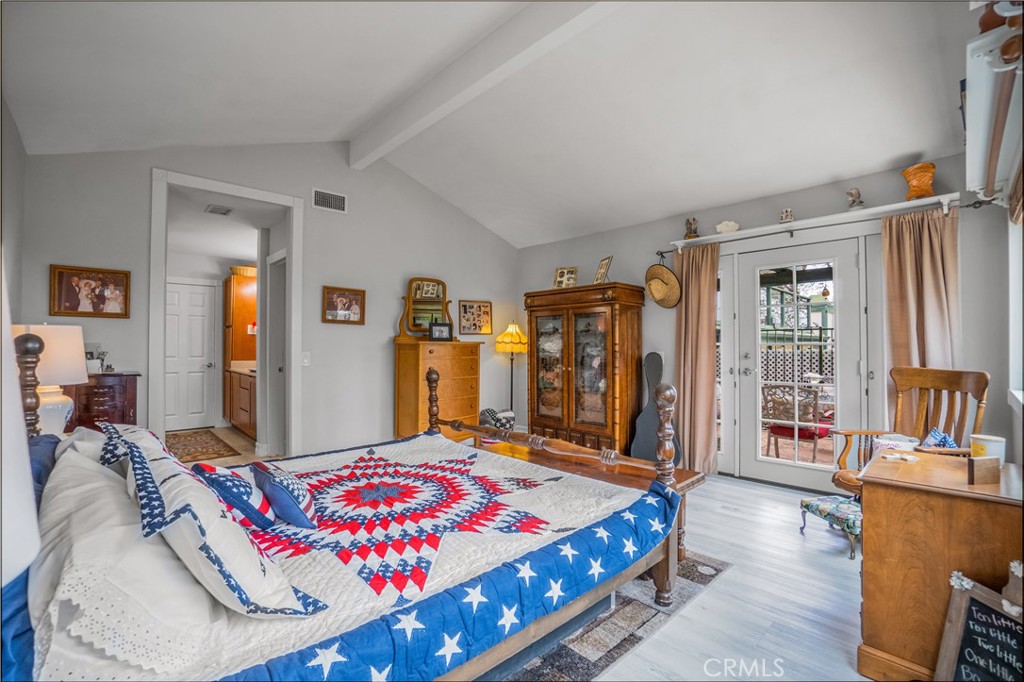 2671 Condor Circle Corona, CA 92882 - Photo 32 of 44 a bedroom with a bed a bookshelf and many windows