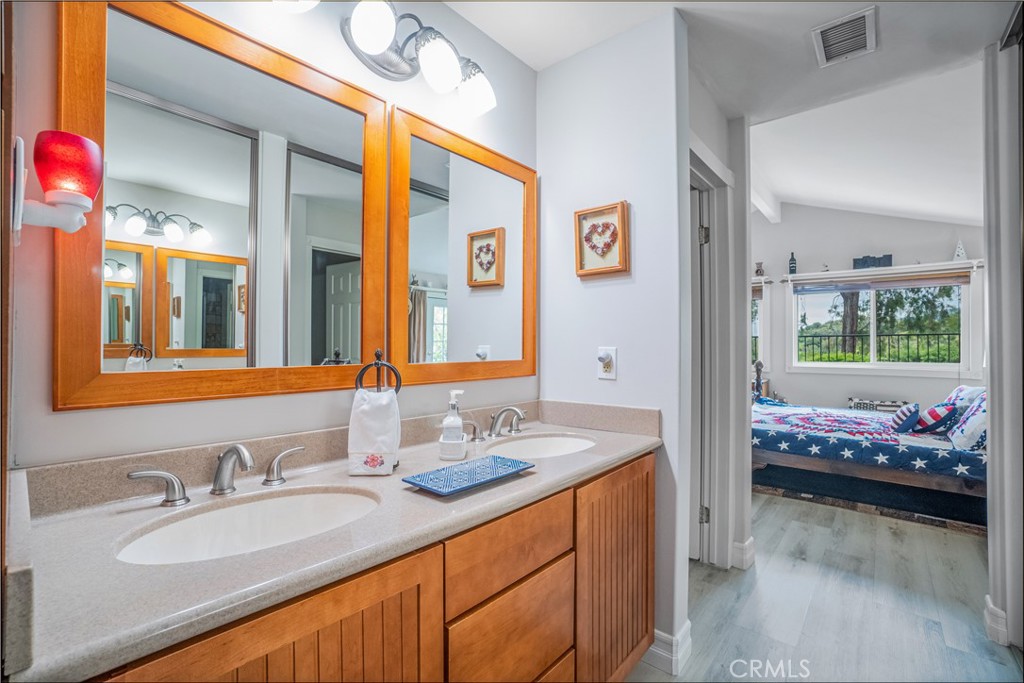 2671 Condor Circle Corona, CA 92882 - Photo 33 of 44 a en suite bathroom with a granite countertop sink and a mirror