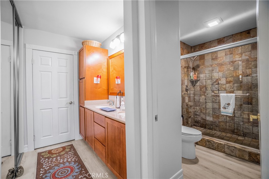 2671 Condor Circle Corona, CA 92882 - Photo 34 of 44 a bathroom with a granite countertop sink a toilet and shower
