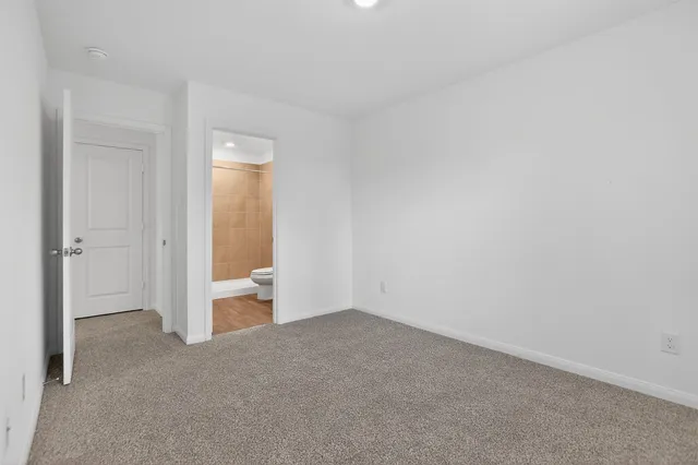 an empty room with an entryway and an empty room
