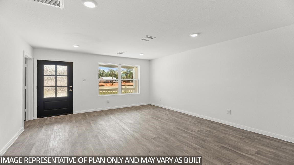 11806 Holly Hurst Drive Willis, TX 77378 - Photo 5 of 11 an empty room with wooden floor and windows