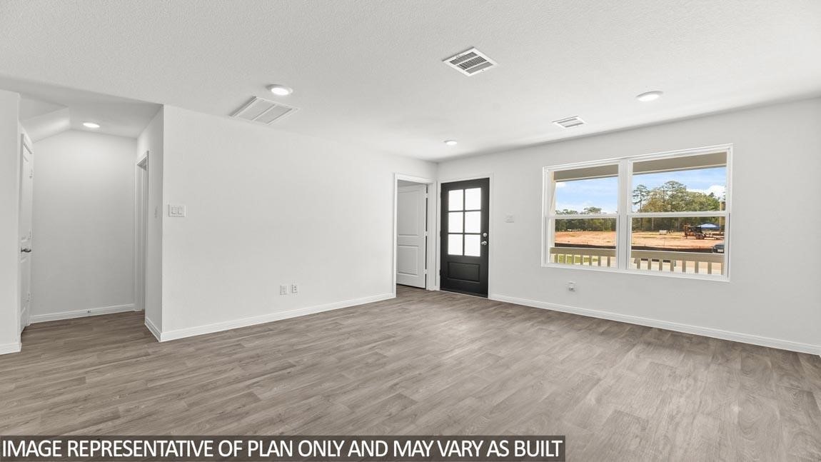 11806 Holly Hurst Drive Willis, TX 77378 - Photo 7 of 11 an empty room with wooden floor and windows