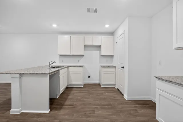 a kitchen with white cabinets and white appliances