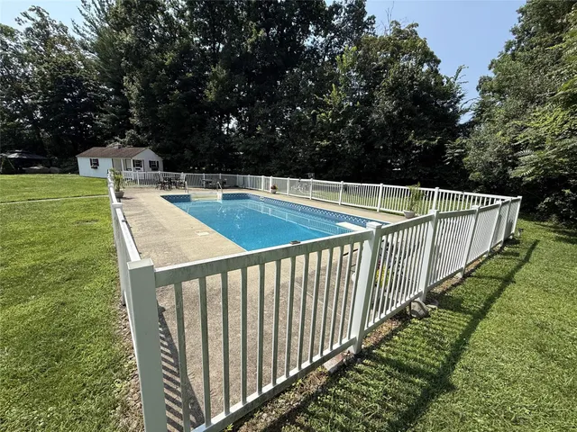 a view of a balcony with yard