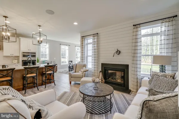 a kitchen with stainless steel appliances granite countertop a sink a stove a dining table and chairs